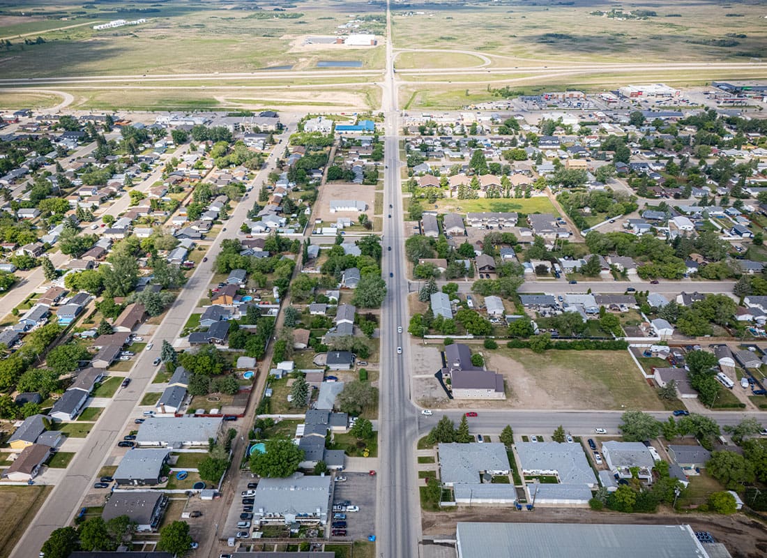 Gun Barrel City, Tx, -City Street With Houses and a Few Cars as the Sun Shines Through a Cloud and the Shadow Goes Across the City
